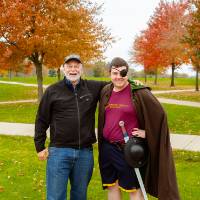 alumni smiling with man in costume